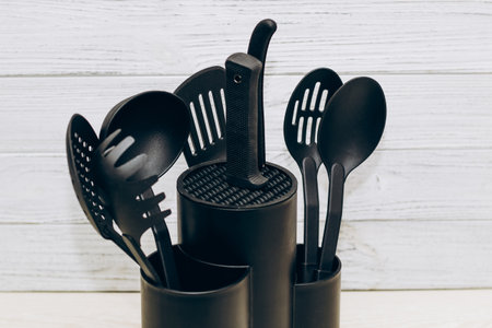 Kitchen tools plastic for multicooker on a wooden table in a dish organizer.の写真素材