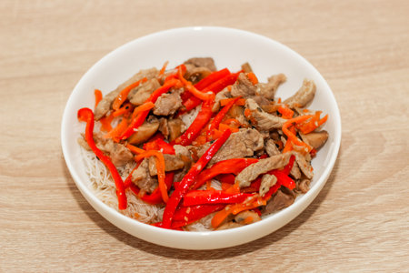Chopped pieces of pork with onion, pepper and sesame with rice glass noodles.の写真素材