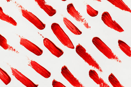Smears of red cosmetic lipstick on a light background.の写真素材