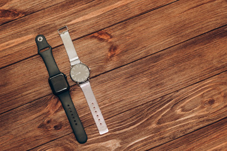 Black technological smart watches and ordinary mechanical watches with a dial.の写真素材