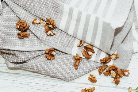 Fresh shelled walnuts on table with kitchen towel.の写真素材