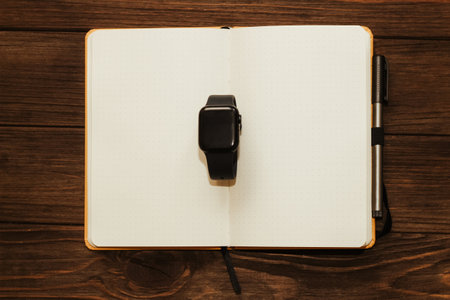 Open notebook diary with clock with black dial, time management concept.の写真素材