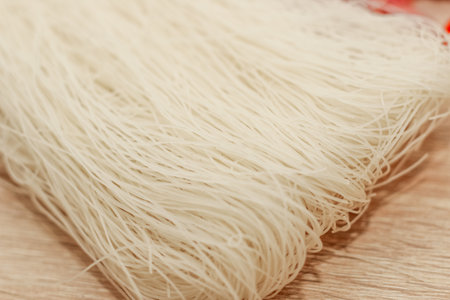 Funchoza rice glass noodles on a wooden board.の写真素材
