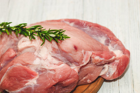 Fresh piece of meat large pork ham on the board.の写真素材