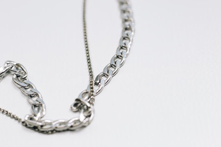 Different silver metal chains on a light background.の写真素材
