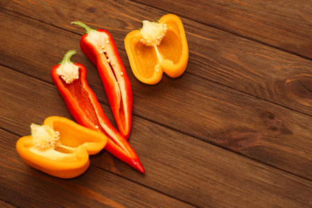 Red pepper Kapi with yellow sweet pepper on a wooden background, space for text.の写真素材