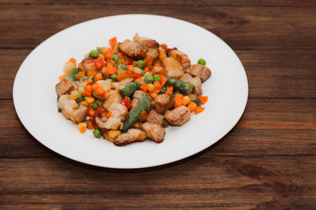 Stewed vegetables with meat, vegetables carrots, peas, beans in a plate.の写真素材