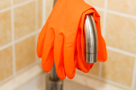 Kitchen sink with faucet and gloves for cleaning.の写真素材