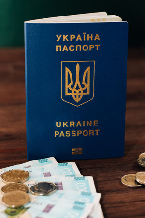 Ukrainian hryvnia money on the table and a Ukrainian passportの写真素材