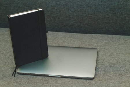 Laptop series flat metal on the table with a business diary.の写真素材