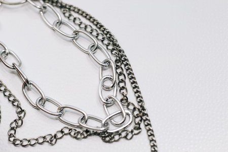 Different silver metal chains on a light background.の写真素材