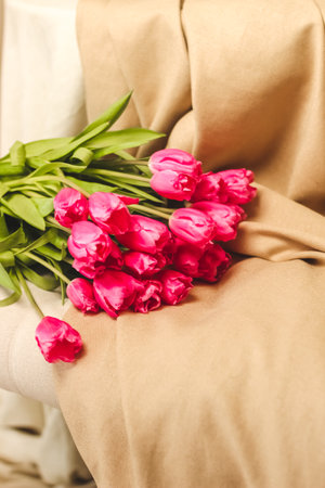 A bouquet of pink flowers sewn on beige stylish linenの写真素材