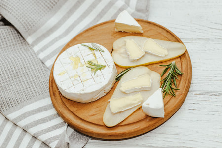 White baguette cut into pieces with olive oil and Camembert cheese on the table.の写真素材
