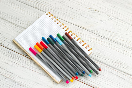 Notebook diary for planning and studying on the table with colored markers.の写真素材