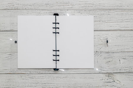 Notebook with rings, checkered sheets, transparent cover, study concept.の写真素材