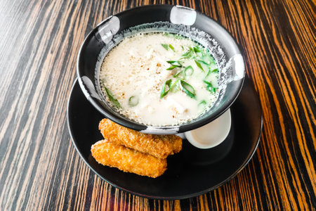 Thai soup Tom Kha Gai in a plate with fish close-up.の写真素材