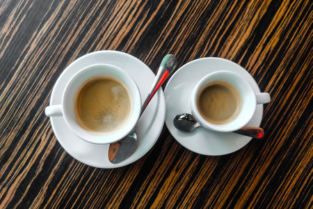 Two cups of cappuccino on a table in a cafe.の写真素材