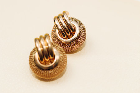 Gold ornaments from yellow metal on a light background.の写真素材
