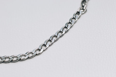 Different silver metal chains on a light background.の写真素材