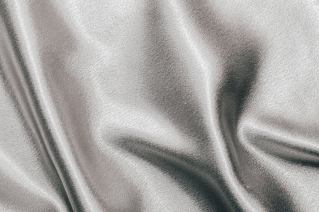 Golden shiny texture of silk satin satin with folds.の写真素材