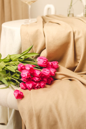 A bouquet of pink flowers sewn on beige stylish linenの写真素材