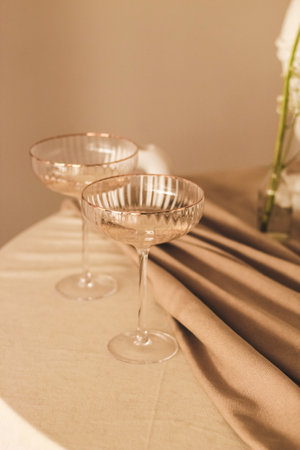 Stylish romantic table setting in the interior with glasses and candlesの写真素材