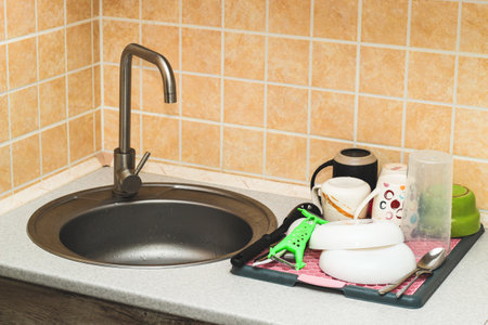 A tray with a grid for drying dishes, a convenient kitchen device.の写真素材