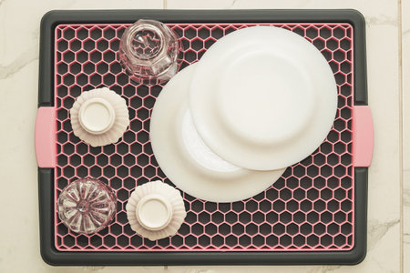 A tray with a grid for drying dishes, a convenient kitchen device.の写真素材