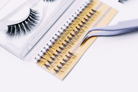 Artificial false fluffy eyelashes with tweezers.の写真素材