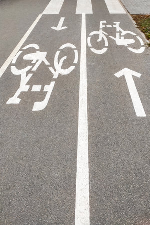 A bicycle path on the asphalt, a bicycle is drawn.の写真素材