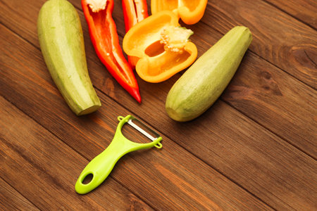 Chopped vegetables, carrots, peppers, zucchini on a vegetable peeler.の写真素材