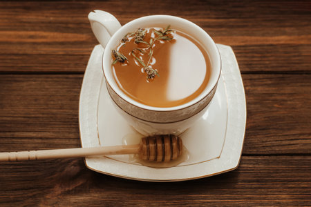 Herbal green tea in a white cup on the table.の写真素材