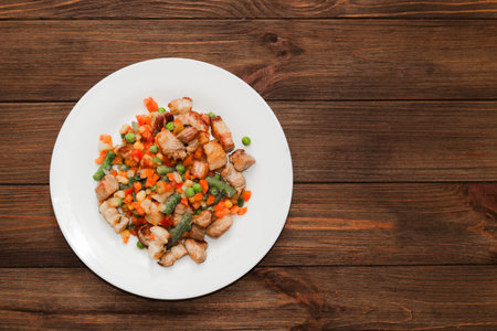 Stewed vegetables with meat, vegetables carrots, peas, beans in a plate.の写真素材