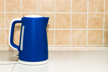 An electric bright kettle heats water in the kitchen.の写真素材