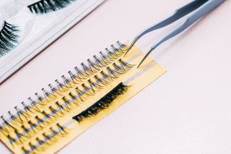 Artificial false fluffy eyelashes with tweezers.の写真素材