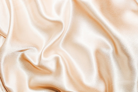Golden shiny texture of silk satin satin with folds.の写真素材