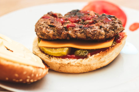 Buns for homemade burgers with ketchup and cutlet lie on a plate.の写真素材