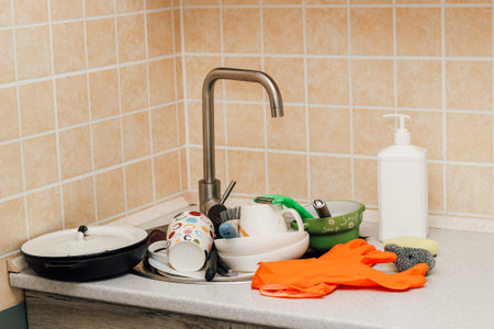 A pile of dirty dishes, cups, plates in the sink.の写真素材