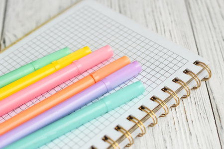 Notebook diary for planning and studying on the table with colored markers.の写真素材