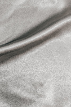 Golden shiny texture of silk satin satin with folds.の写真素材