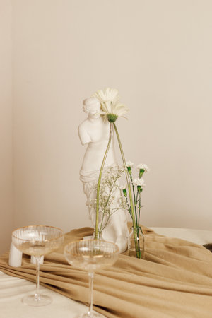 Stylish romantic table setting in the interior with glasses and candlesの写真素材