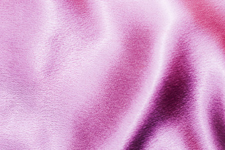 Pink shiny texture of silk satin satin with folds.の写真素材