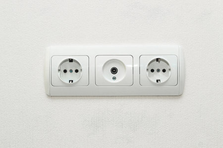 Sockets in the wall together with an input for an antenna for television.の写真素材