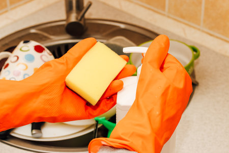 A pile of dirty dishes, cups, plates in the sink, washing with an eraser.の写真素材