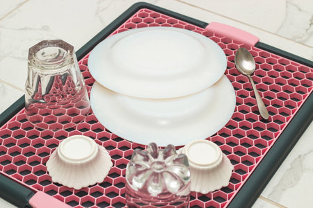 A tray with a grid for drying dishes, a convenient kitchen device.の写真素材