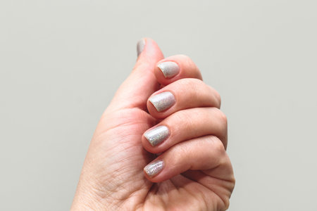 Shiny gel polish on nails, women's manicure.の写真素材