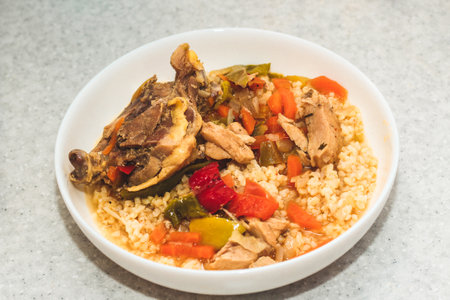Stewed poultry with vegetables, carrots and peppers with bulgur.の写真素材