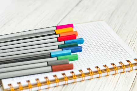 Notebook diary for planning and studying on the table with colored markers.の写真素材