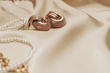 Women's jewelry, gold chain, trendy jewelry on a silk background.