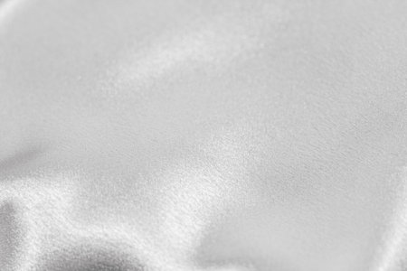 Golden shiny texture of silk satin satin with folds.の写真素材